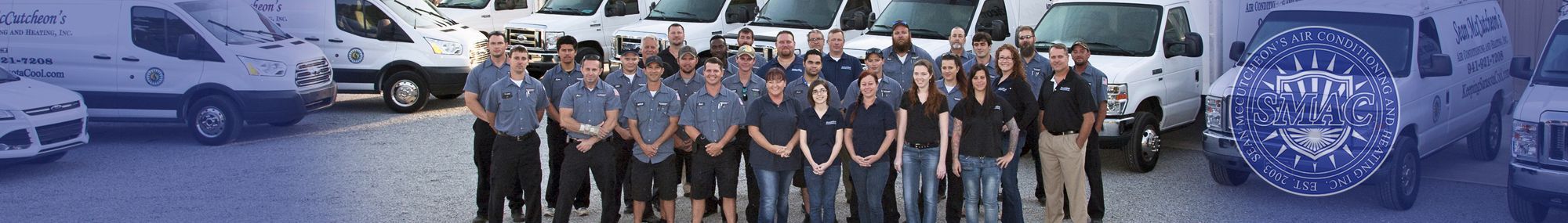 Sean McCutcheon's Air Conditioning and Heating team in front of the SMAC fleet