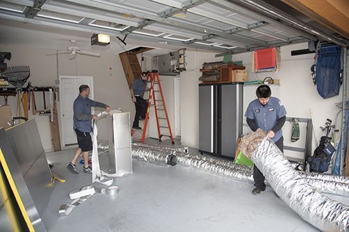 Sean McCutcheon's service technician installing new ductwork.